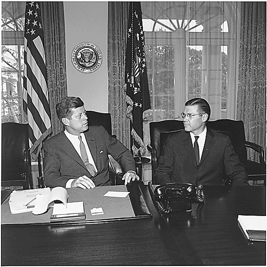 President John F. Kennedy meets with Secretary of Defense Robert McNamara in the Cabinet Room on June 1962. Image by Cecil Stoughton, courtesy of Wikimedia Commons. 