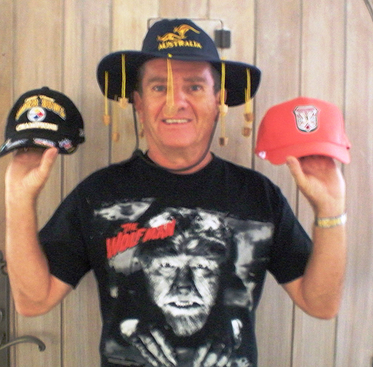Butch poses with some hats that he owns, while wearing a wolfman T-shirt. He is part owner of a T-shirt company called Universal Monsters.