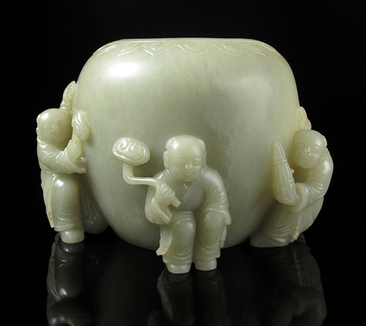 Chinese fine jade brushwasher with three boys, Qing Dynasty, carved with three children playing with ruyis knot of ribbon and instrument,10.5 centimeters high. Joyce Gallery Auction image.