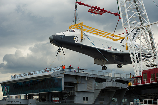Space Shuttle Enterprise being lifted off a barge and into place at the Intrepid Sea, Air & Space Museum on June 6, 2012. Photo: NASA/Bill Ingalls.