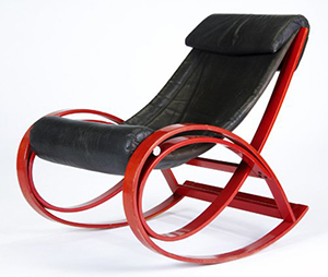 Gae Aulenti designed this rocking chair of enameled wood and leather upholstery. Image courtesy of LiveAuctioneers.com Archive and Rago Arts and Auction Center.