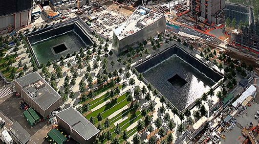 Photo of the World Trade Center 9/11 Memorial as it appeared in June 2012. Photo taken from the World Financial Center by Cadiomals, licensed under the Creative Commons Attribution-Share Alike 3.0 Unported license.