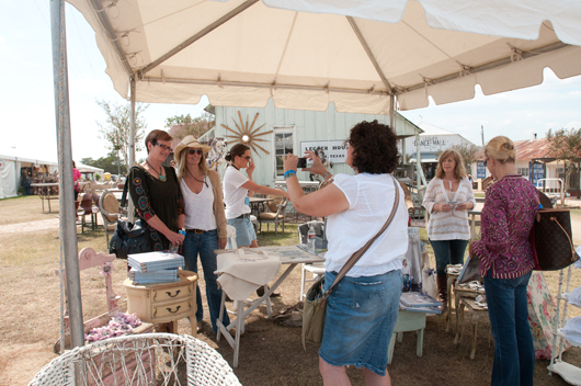 Rachel Ashwell, who had a book signing at the show, poses for photographs. Marburger Farm Antique Show image. 