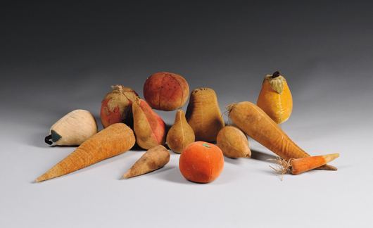 Painted velvet fruit and vegetables, 19th and 20th century, including a strawberry, six pears, an apple, tomato, two carrots, and two turnips, to large 10 1/2 inches. Estimate: $200-$300. Skinner Inc. image.