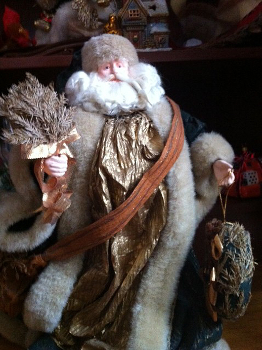 Woodsy-looking Santa purchased in Milan, Italy; 1ft tall and carrying a wreath made of sticks and twigs and a bundle of evergreen.