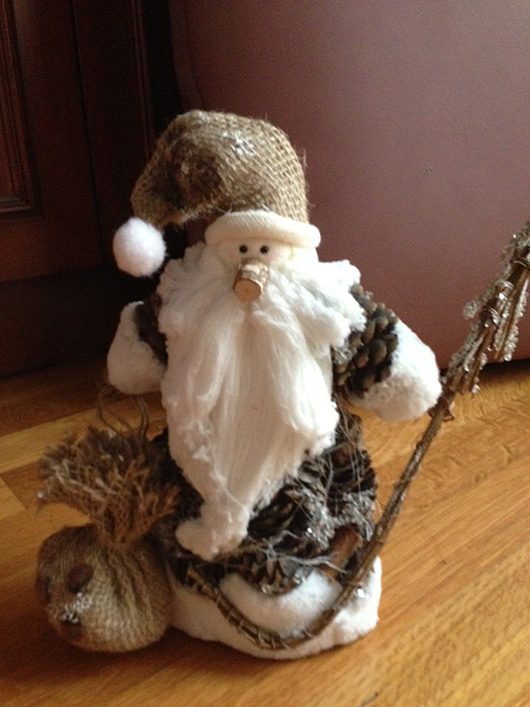 Santa made of pine cones for the body, with a cork nose and burlap hat and sack, purchased in Yaroslavl, Russia.