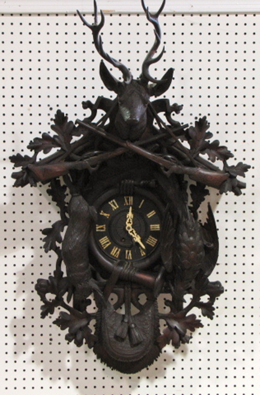 Carved Black Forest wall clock, 39 inches tall, very good except a damaged pendulum. Price realized: $2,938. S&S Auction image.