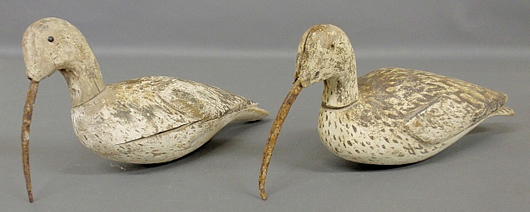 Two carved wood and paint decorated curlew shore bird decoys with metal beaks. Estimate: $700-$900. Wiederseim Associates Inc. image.