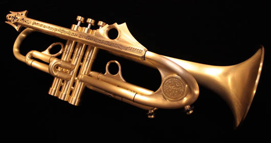 Custom-made by Jason Harrelson, the trumpet features a fleur-de-lis mouthpiece receiver, engraved 'Satchmo,' with transcription of Louis Armstrong’s solo for the song 'A Kiss to Build A Dream On,' a tuning slide mounted with the iconic New Orleans water meter cover, and multiple finger button inlays in blue, purple, green and black onyx. Estimate: $5,000-$8,000. Neal Auction Co. image.
