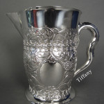 Beautiful and unique repousse-decorated Tiffany & Co. sterling silver 5-pint pitcher, circa 1891-1902. Possibly a custom-made piece. Height: 8 1/4 inches. Width: 9 1/2 inches. Sterling Associates image.