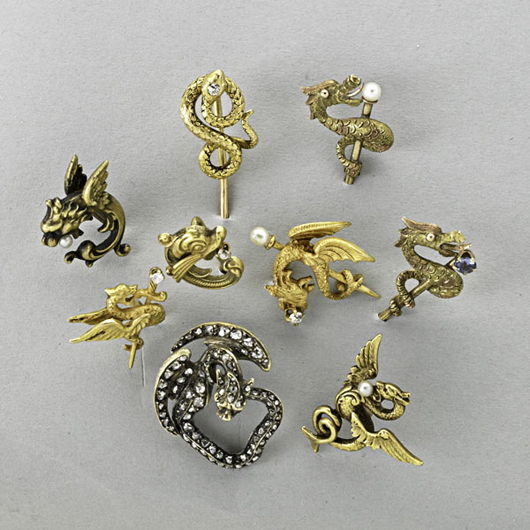 Nine gold dragon, griffon or serpent stick pins, to be sold Dec. 9. Estimate; $900-$1,200. Rago Arts and Auction Center image.