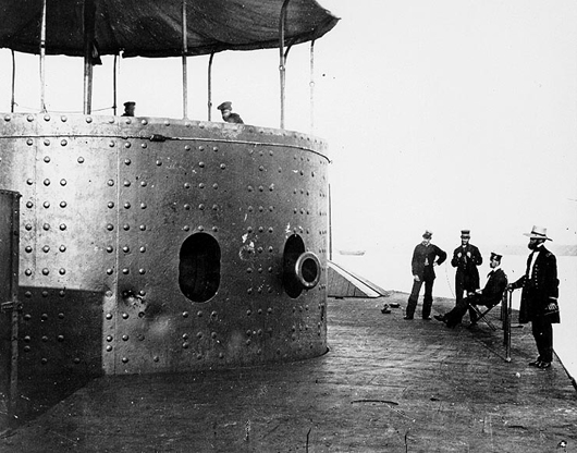 View on deck of the USS Monitor looking forward on the starboard side, while the ship was in the James River, Va., July 9,1862. The turret, with the muzzle of one of the ironclad's two XI-inch Dahlgren smoothbore guns showing, is at left. Image courtesy Wikimedia Commons.