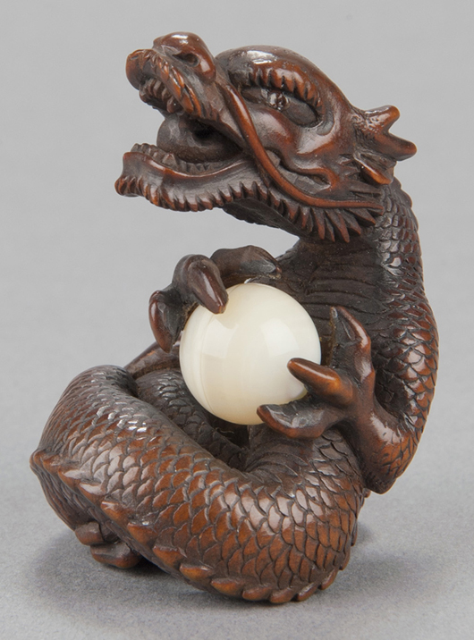 Wood netsuke of roaring dragon holding ball, carved by Kaigyokudo, Osaka, circa 1833-1843, signed by artist. Est. $7,000-$9,000. Quinn’s Auction Galleries image.