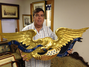 Auctioneer Tim Chapulis shows off this gorgeous antique carved oak eagle that made $9,000. Tim’s Inc. image.