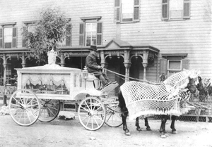 Circa-1900 horse-drawn funeral hearse with driver. Image courtesy of Neil Regan Funeral Home, Scranton, Pa. Image licensed under the Creative Commons Attribution-ShareAlike 2.5 License.