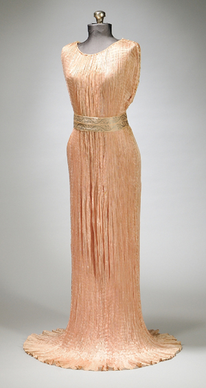 Signed Mariano Fortuny silk pleated ‘Delphos’ gown with Venetian glass beadwork, circa 1910, Venice, Italy, length approximately 64 inches. Estimate: $4,000-$5,000. Skinner Inc. image.