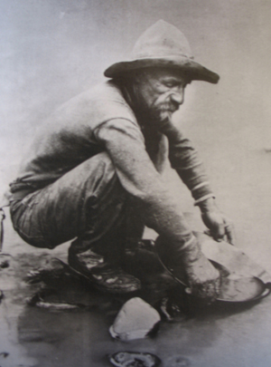 A 'forty-niner' panning for gold in California's American River. Image courtesy Wikipedia Commons.
