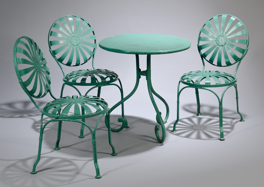 Set of six green-painted iron ‘cushion seat’ garden chairs and a circular table, circa 1925. Estimate: $300-$500. Skinner Inc. images.