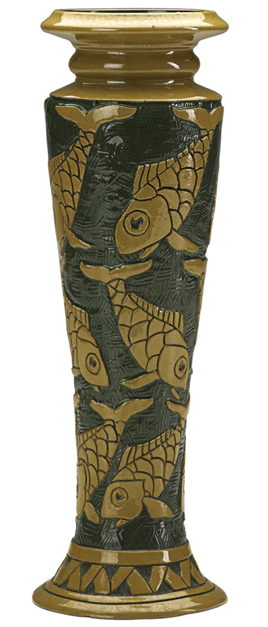 This vase is decorated with fish carved into the clay, so the designs are raised. It sold for more than $3,000 at a Rago auction last June. Early Roseville with hand decoration sells for more than later molded pieces. The vase is marked with the raised Rozane Ware medallion.