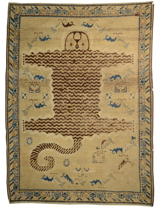 Whimsical Tibetan tiger rug, 6 feet 10 inches x 5 feet 1 inch. Estimate: $3,000-$5,000. Grogan and Co. Fine Art Auctioneers.