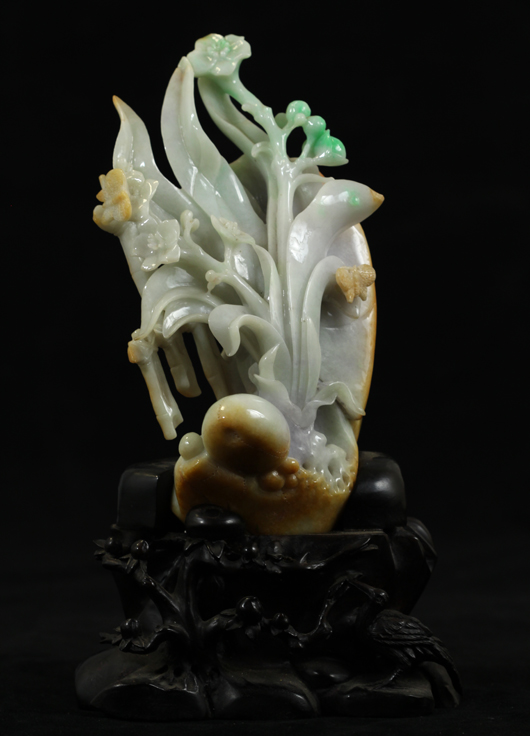 Carved jadeite sculpture of orchid flowers in four beautiful color tone of green, lavender, beige and white. China Arts image.