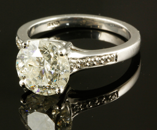 Platinum and diamond ring, 3.00-carat round center stone flanked by 12 smaller round brilliant cut diamonds. Price realized: $12,000. Kaminski Auctions image.