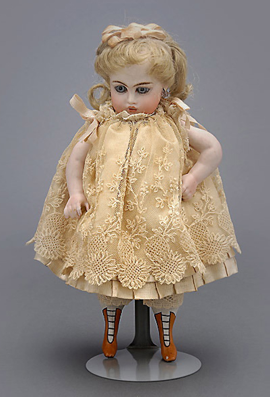 German bisque head doll with glass globe. Price realized: $767. Michaan’s Auction image.