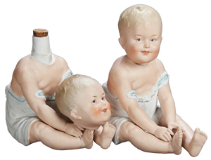 The beheaded doll has a glass decanter hidden inside, and so does her 'headed' twin. The pair sold for $969 at a June 2012 Theriault's doll auction in Annapolis, Md.