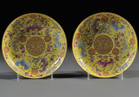 Pair of small famille rose dishes, China, 20th century, decorated with five bats in five colors, interspersed with peaches and scrolls, on bright yellow background, gilt rim, six-character marks on recessed bottom. Estimate: $500-$800. Skinner Inc. image.