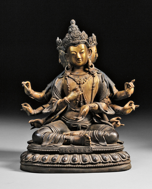Bronze Buddha, China, 18th/19th century, the four-face, eight-arm figure seated on a single lotus throne, with hand gestures of charity, teaching, and meditation, Qianlong mark on front. Estimate: $800-$1,000. Skinner Inc. image. 