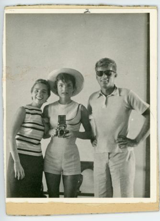 Photo of Ethel Kennedy, Jackie with camera and John Kennedy. John McInnis Auctioneers image.