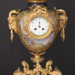 Rare 19th century Sevres clock in urn form, hand-painted and artist-signed, 26 inches tall. Stevens Auction Co. image.