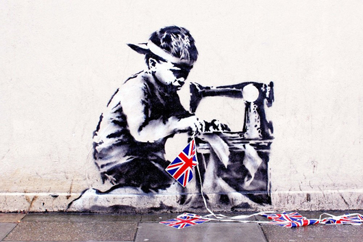 Banksy's 'Slave Labour (Bunting Boy),' is being offered again in London, say auctioneers. The mural measures 48 by 60 inches. Image courtesy of LiveAucitoneers.com and Fine Art Auctions Miami.