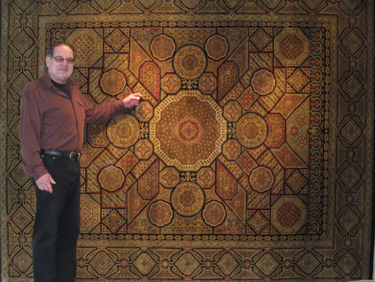 Owner Bob Anderson with Celtic-style carpet from India. Aaron's Oriental Rug Gallery image. 
