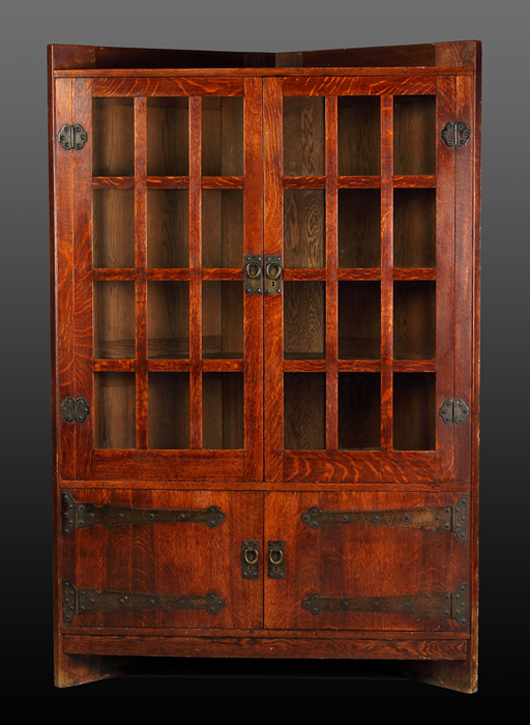 1905 Gustav Stickley oak corner cupboard with original finish and copper strap hardware. Cottone Auctions image.
