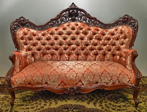 The sofa of a four-piece Meeks laminated rosewood rococo parlor suite, which sold for $24,150. Stevens Auction Co. image.
