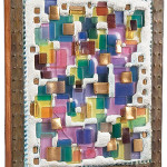 This fused-glass sculpture is a multicolored mosaic embedded in concrete and framed in brass. It's marked 'Higgins.' It sold for $210 a few years ago at Jackson's Auctioneers in Cedar Falls, Iowa.