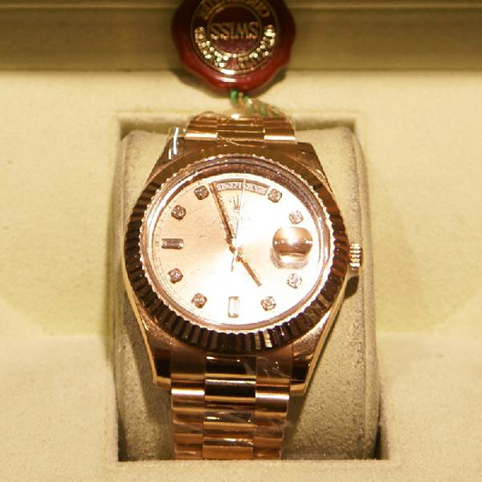 Rose gold men's Rolex Day-Date II (new model) watch. Government Auction image.