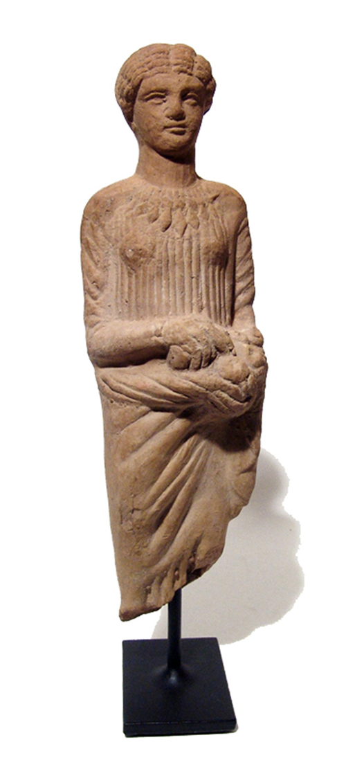 Greek terra-cotta figure of a woman, circa 5th Century BC, wearing chiton and himation; necklace with large diamond-shaped pendant beads. Ex English private collection, acquired prior to 1980. Ancient Resource image.