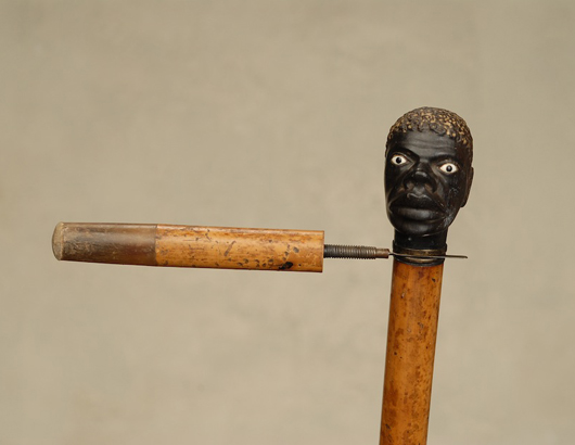 Beheading gadget cane depicting a black man. Tradewinds Antiques image.