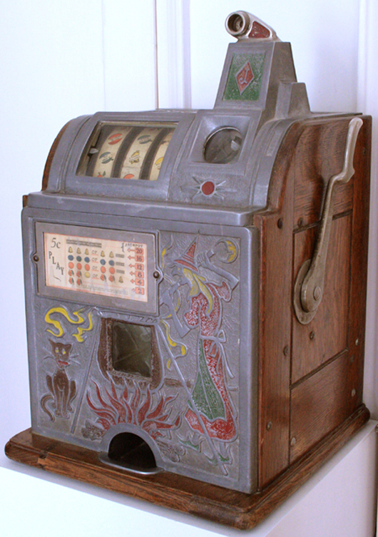 Extremely rare Jennings witch with black cat 3-reel slot machine from 1st quarter of 20th century. Ross Art Group image.