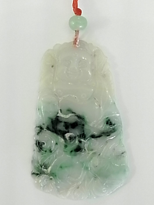 Hand-carved jadeite Buddha relief amulet pendant from a selection of a selection of estate Orientalia. Hess Fine Auctions image.  