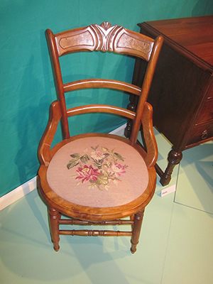 This side chair features handmade needlework often found on parlor furniture. The piece also has a maple burl veneer along the back top rail. Courtesy of the Museum of the South Dakota State Historical Society.