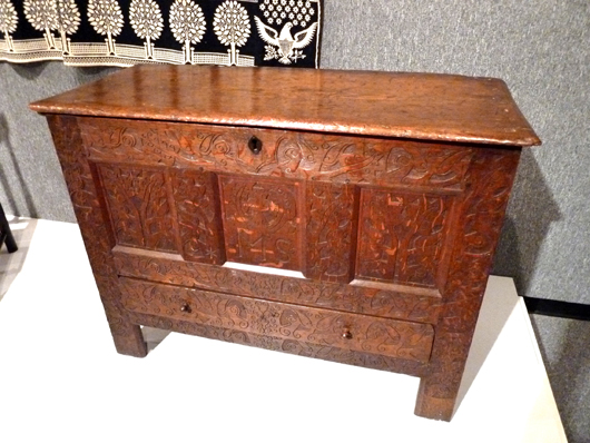 The next eyeful is a Hadley chest circa 1694 from Hadley, Mass, also a gift of the Dows. The style was named for the town and similar chests were made there from around 1675 to 1740. It is made with elaborate shallow vine and flower carvings in oak and pine and has the initials ‘MS’ in the center panel, probably those for whom the chest was made. The large chest was often the only piece of furniture owned by Colonists and served as storage chest, treasure chest, table, bench and desk. American chests had flat tops usually pine to serve as sitting areas unlike those of European counterparts who had paneled tops.