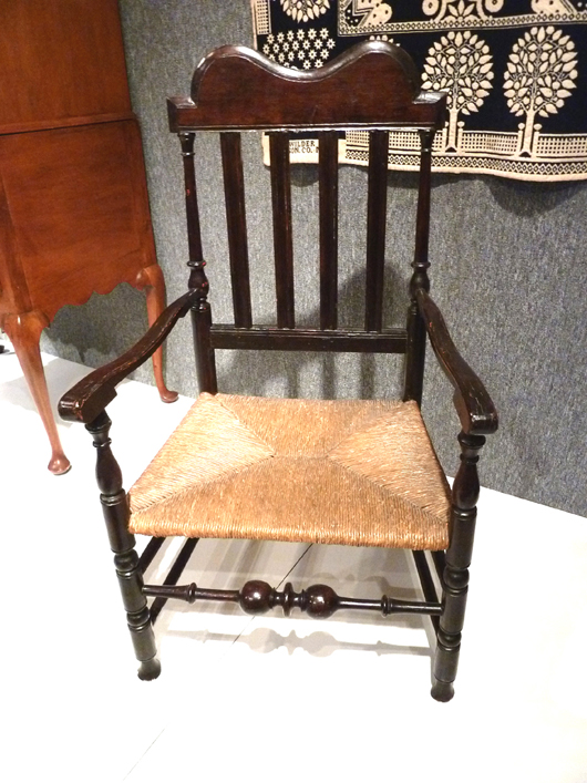 Next up, and don’t even think about sitting down, is a William and Mary chair from the Delaware Valley of Pennsylvania, circa 1710. Made of carved, turned and painted oak with a woven natural rush seat this chair shows the verticality of the William and Mary style.
