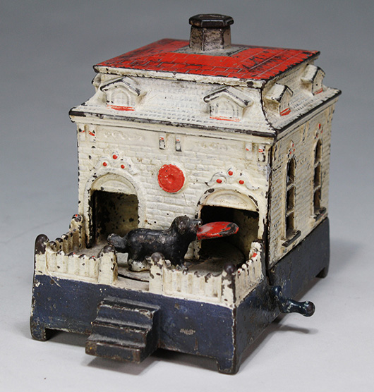 One of three known Dog on Turntable cast-iron mechanical banks in red, white and blue paint scheme, ex Donal Markey collection, est. $4,000-$6,000. RSL Auction Co. image.