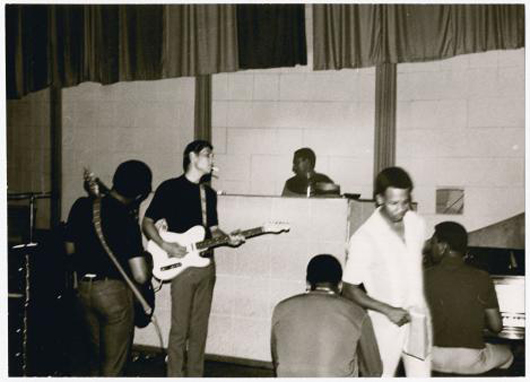 Among the rare Studio A photographs in the Jonas Bernholm exhibit currently on view at the Stax Museum of American Soul Music is this one that includes several legendary Memphis musicians: James Alexander (shown from behind) on bass, Steve Cropper on guitar, Al Jackson Jr on drums, then-unknown singer/songwriter Eddie Floyd (standing) and Booker T Jones on keyboard. Photo courtesy of Stax Museum of American Soul Music.