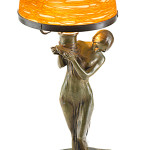 This lamp, created from a figure of a bronze woman and an iridescent gold glass shade made by Loetz, is 14 inches high. The signed lamp sold this spring for $3,750 at Rago Arts and Auction Center in Lambertville, N.J.