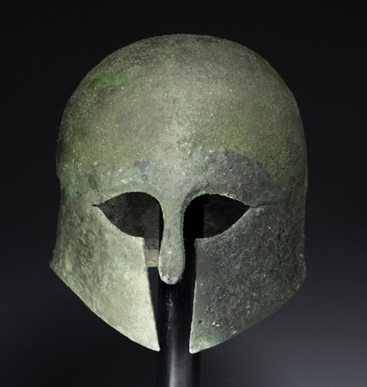 Greek Corinthian bronze helmet, est. $30,000-$45,000. Antiquities Saleroom image.