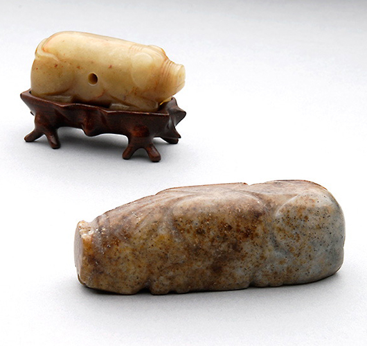 Two jade figures of pigs, Han Dynasty.Sold for $50,150. Michaan's image.
